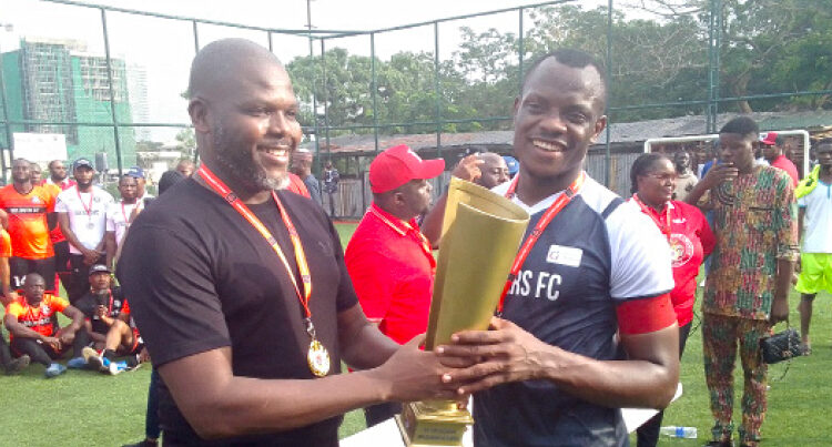 Former chairman of NBA, Lagos branch, Chukwuka Ikwuazom (SAN) presents to the captain Glaciers FC, winner of the 2024 Abuja Lawyers League