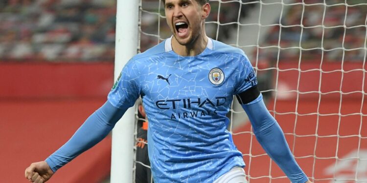 Soccer Football - Carabao Cup - Semi Final - Manchester United v Manchester City - Old Trafford, Manchester, Britain - January 6, 2021 Manchester City's John Stones celebrates scoring their first goal Pool via REUTERS/Shaun Botterill EDITORIAL USE ONLY. No use with unauthorized audio, video, data, fixture lists, club/league logos or 'live' services. Online in-match use limited to 75 images, no video emulation. No use in betting, games or single club /league/player publications.  Please contact your account representative for further details.