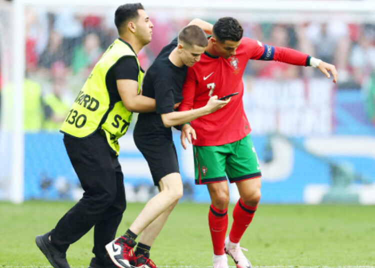 Cristiano Ronaldo mobbed by selfie-hunting pitch invaders in major Euro 2024 security breach