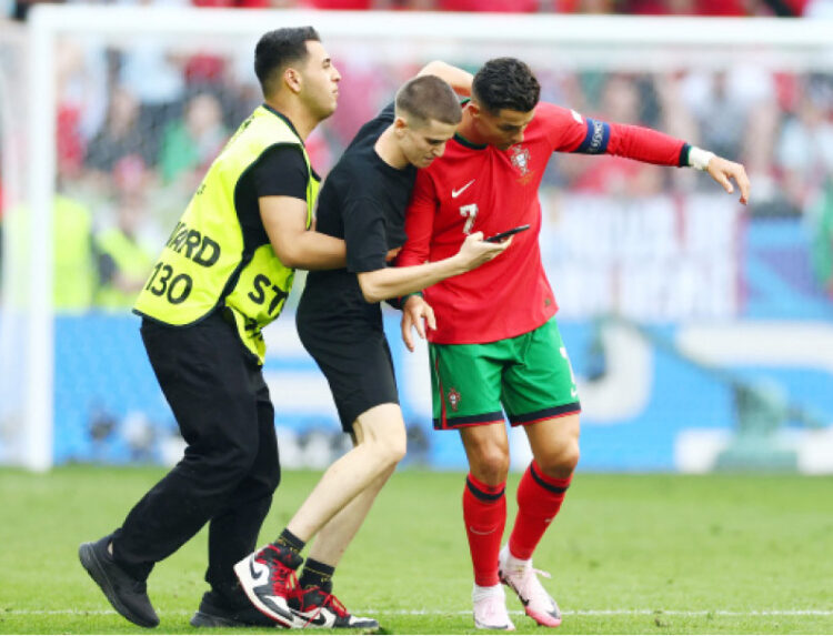 Cristiano Ronaldo mobbed by selfie-hunting pitch invaders in major Euro 2024 security breach