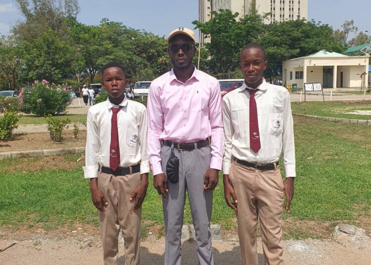 From right, Chibueze Emmanuel (Right), Onoko Oyemike Oji Volunteer from Saint Victoria's Art Outreach (Middle), and Chibuike Collins
 to the left.