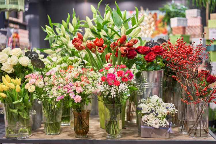 Vases with different colored flowers, showcase flower shop. Beautiful spring bouquets. . Small family business. Work florist. copy space.