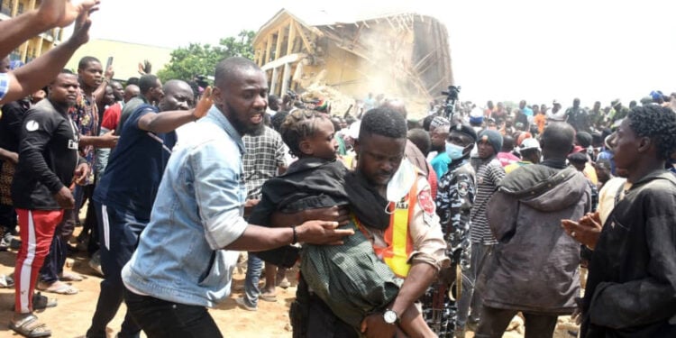 Pic.9. People rescue one of the students of the Collapsed Saint Academy School, Jos on Friday (12/7/24).

0159/JULY/12/7/2024/Sunday Adah/MO/NAN