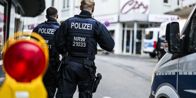 Police officers stand at a cordon in the city center in the early morning in Solingen, Germany, Saturday, Aug. 24, 2024, following Friday's deadly attack at the city's 650th anniversary celebrations. (Christoph Reichwein/dpa via AP)