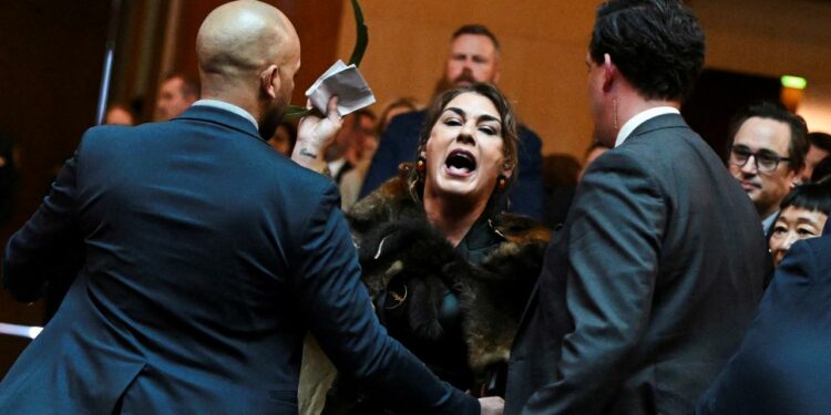 Lidia Thorpe (centre) being escorted out by security men.