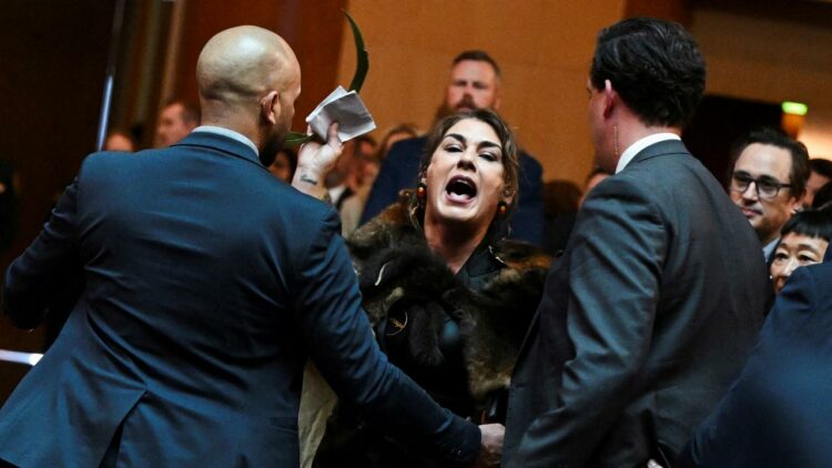 Lidia Thorpe (centre) being escorted out by security men.