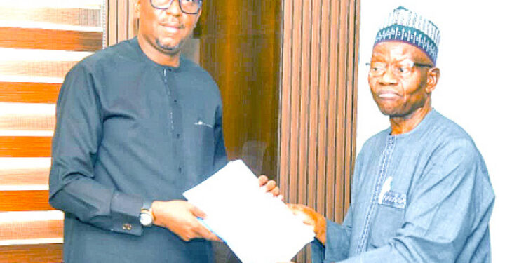 L-R: Chairman, National Sports Commission (NSC), Shehu Dikko, presenting documents to president, Nigeria Olympic Committee (NOC), Engr Habu Gumel after a meeting in Abuja on Tuesday.