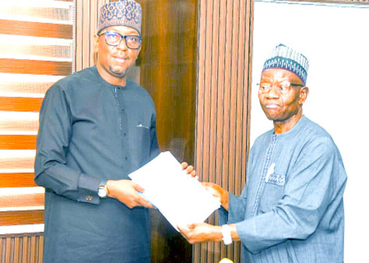 L-R: Chairman, National Sports Commission (NSC), Shehu Dikko, presenting documents to president, Nigeria Olympic Committee (NOC), Engr Habu Gumel after a meeting in Abuja on Tuesday.