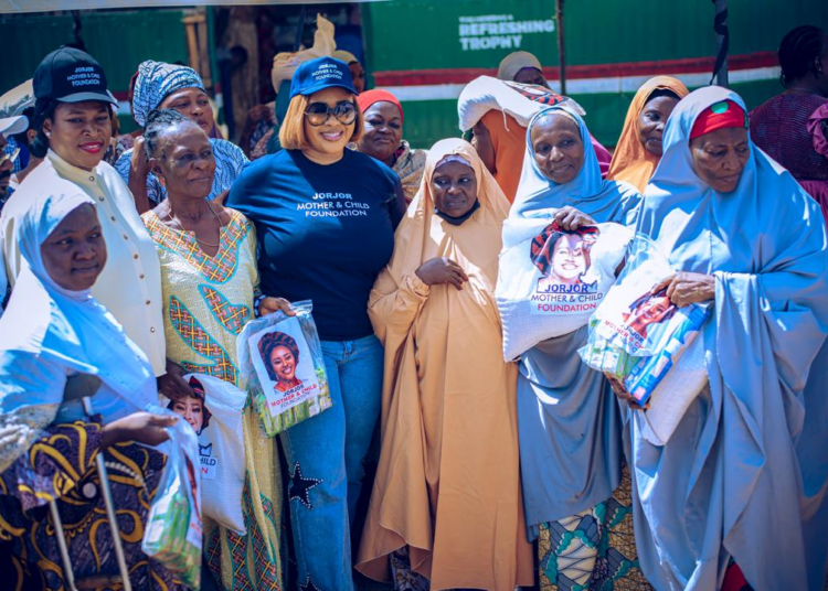 Founder/CEO, JorJor Mother and Child Foundation, Engr Mrs Anjor Obande(M); Guest Speaker/Founder, Olean Care Aid Foundation (OCAF), Mrs Oge Ezenyimulu-Nwagu(3rd, L), with some beneficiaries during the foundation's humanitarian outreach in Mpape Community, Abuja.