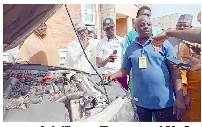 The vice chancellor of KWASU, ( 1st left ), Prof.  Jimoh Shaykh- Lukman and Mr AbdulAzeez Akande( in blue t- shirt) showcasing one of the vehicle the institution converted to CNG. Photo by Abdullahi Olesin, Ilorin.