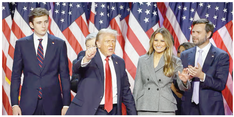 US President-elect, Donald Trump, gestures next to his wife, Melania Trump, son Barron Trump and Vice President-elect, JD Vance, following early results from the 2024 U.S. presidential election in Palm Beach County Convention Centre, in West Palm Beach, Florida, yesterday. PHOTO: REUTERS
