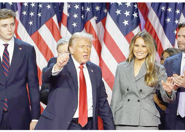 US President-elect, Donald Trump, gestures next to his wife, Melania Trump, son Barron Trump and Vice President-elect, JD Vance, following early results from the 2024 U.S. presidential election in Palm Beach County Convention Centre, in West Palm Beach, Florida, yesterday. PHOTO: REUTERS