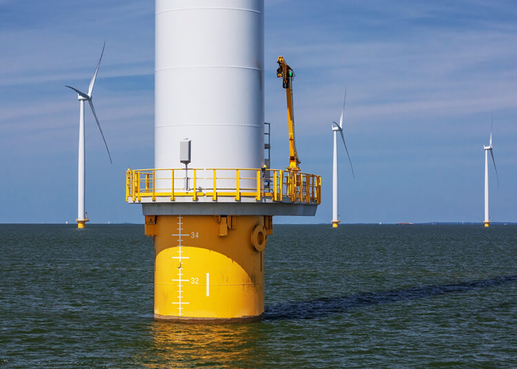 Detail of an offshore wind turbine with monopile foundation and maintenance platform and lower part of the tower in the Windpark Noordoostpolder on the IJsselmeer in the Netherlands, Flevoland