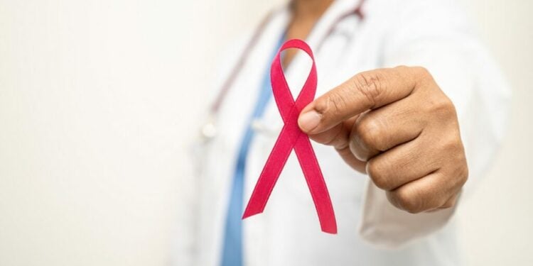 Breast cancer, Asian doctor woman with pink ribbon, symbol of World Breast Cancer Day.