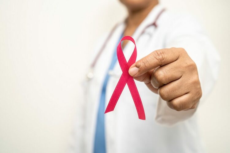 Breast cancer, Asian doctor woman with pink ribbon, symbol of World Breast Cancer Day.