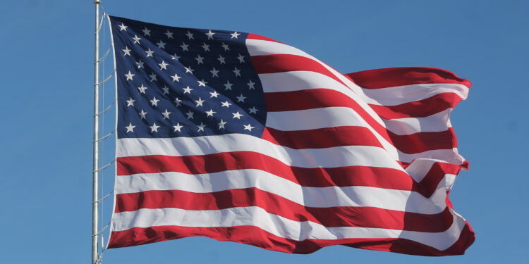 American Flag Waving on a Flag Pole 750x375 1