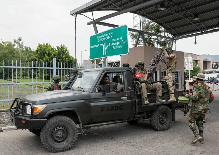 FILE PHOTO: M23 rebels gather around a truck during the escort of captured FDLR members (not pictured) to Rwanda for repatriation, at the Goma-Gisenyi Grande Barrier border crossing, March 1, 2025. REUTERS/Arlette Bashizi/File Photo