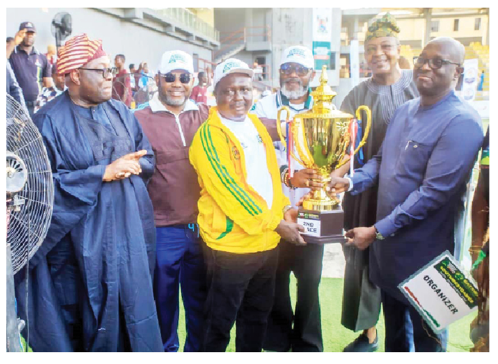 First Bank Reaffirms Commitment To Youth And Sports Development 1 L-R: Dele Momodu; director-general, Lagos State Sports Commission, Lekan Fatodu; President, South West Games, Lanre Alfred; reps of Ogun State, winner of second place and executive director, retail banking of First Bank of Nigeria Limited, Oluseyi Oyefeso, presenting trophy to Ogun representative