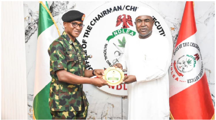 L-R: NYSC Director General, Brigadier General Olakunle Nafiu making a presentation to the Chairman/CEO of National Drug Law and Enforcement Agency (NDLEA), Brigadier General Buba Marwa (rtd) during his courtesy visit to the NDLEA Headquarters in Abuja, yesterday. PHOTO BY IBRAHIM MOHAMMED
