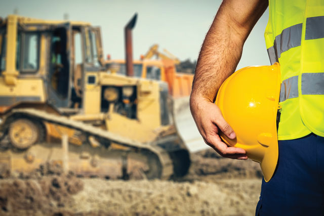 Grinding Gears: Hidden Health Hazards Facing Heavy-duty Machinery Workers 1 construction worker holding hard hat 1