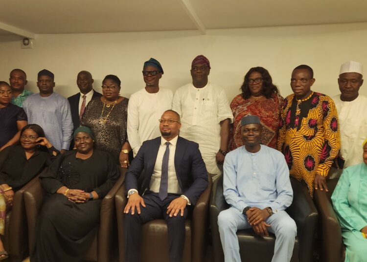 The Director-General of SMEDAN, Charles Odii, (3rd from right on front row), members of his management team and journalists during an interactive session in Abuja.