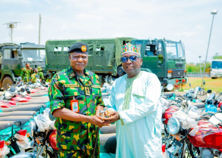 The senior special assistant on Security, Muideen Aliyu (right) handing over the keys of 150 off- road motorcycles that the state government donated to the Nigerian Army.