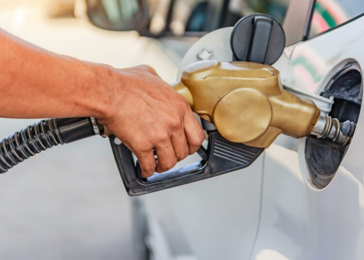 JEB6FF Hand refilling the car with fuel at the gasoline station