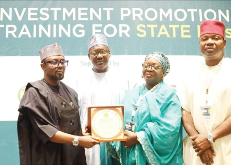 Members of FoSIPAN leadership, Muhktar Nadama ( 2nd L), Maryam Shehu ( 2nd R)  and Anthony Elekeokwuri ( R) presenting Award of Champion of Subnational Investment Reform to Governor Muhammad Inuwa Yahaya of Gombe State ( Represented by Commissioner of Finance,  Muhammad Gambo Magaji).