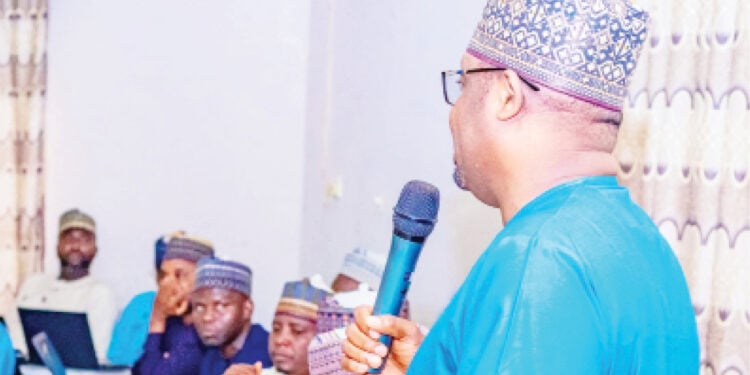 The Executive Secretary  YSCHMA, Dr Babagana Tijjani (With Mic) during the agency's financial review workshop in Dutse, Jigawa State