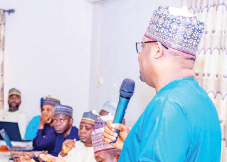 The Executive Secretary  YSCHMA, Dr Babagana Tijjani (With Mic) during the agency's financial review workshop in Dutse, Jigawa State