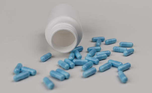 Close up view of generic blue pills. Opiate and heroin overdoses have skyrocketed in recent years IV