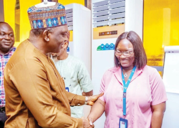 The executive secretary, Nigerian Shippers' Council (NSC), Dr Pius Akutah, in a handshake with senior information officer, NSC, Idowu Abike, during the official launch of the Succession Planning Strategy: Middle Management Leadership Development Programme (MMLDP) for middle-level officers of the Council in Lagos.