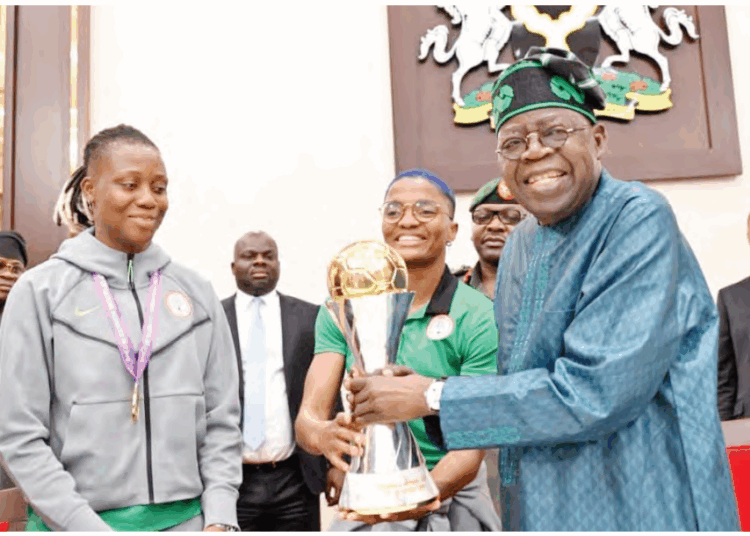President Bola Ahmed Tinubu (right) with the Women’s Africa Cup of Nations (WAFCON) trophy alongside members of the Super Falcons during their visit to the Presidential Villa to present the trophy to the president in Abuja, yesterday PHOTO BY STATE HOUSE