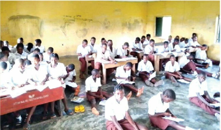 Students of Enekorogha Grammar School,  Burutu local government area of Delta state, sit on the bare floor to attend classes and take examinations. PHOTO FELIX