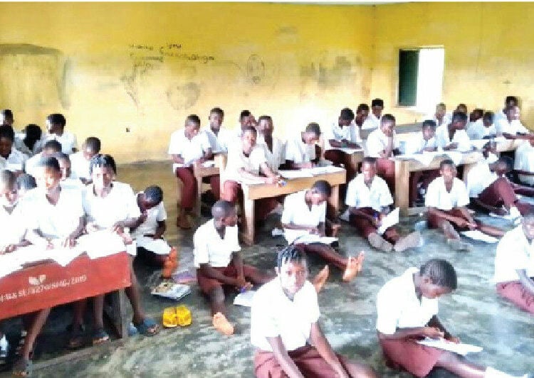 Students of Enekorogha Grammar School,  Burutu local government area of Delta state, sit on the bare floor to attend classes and take examinations. PHOTO FELIX