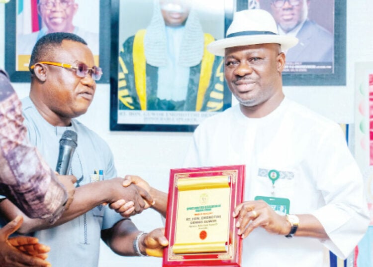 National President, SWAN, Comrade Isaiah Benjamin presenting plaque on the Award of Excellence in Sports Development to the Speaker of the Delta State House of Assembly, (DSHA), Hon Dennis Guwor in Asaba on Tuesday. PHOTO: FELIX LGBEKOYI