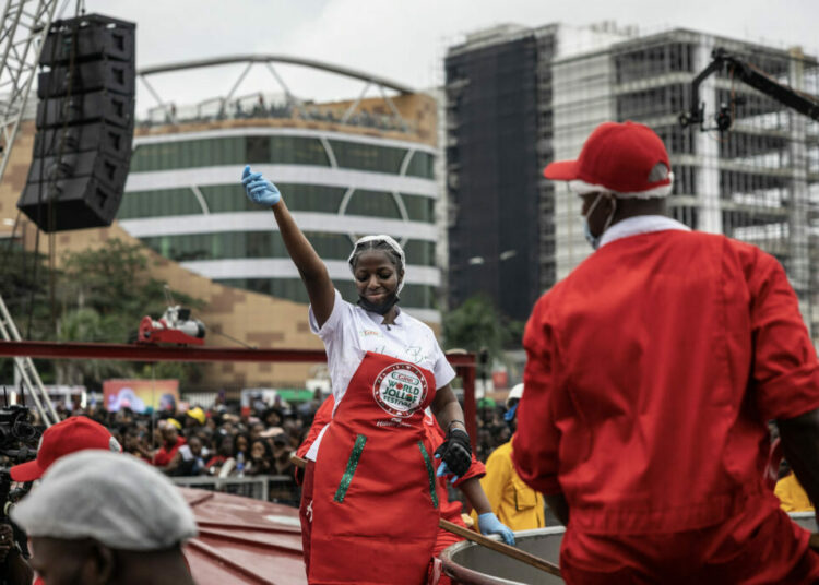 Hilda Baci Nigerian chef Hilda Baci (L) dances as she stands next to a giant pot during an attempt to break the world record for the largest pot of Jollof rice, led by Nigerian chef Hilda Baci in Lagos, on September 12, 2025. (Photo by OLYMPIA DE MAISMONT / AFP)