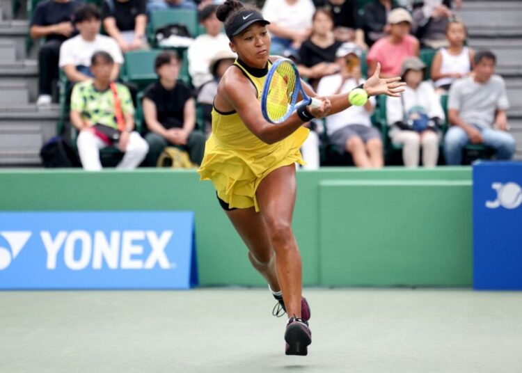 Japan's Naomi Osaka hits a return to Netherlands' Suzan Lamens in their women's singles match at the Japan Open tennis tournament in Osaka on October 15, 2025. (Photo by PAUL MILLER / AFP)