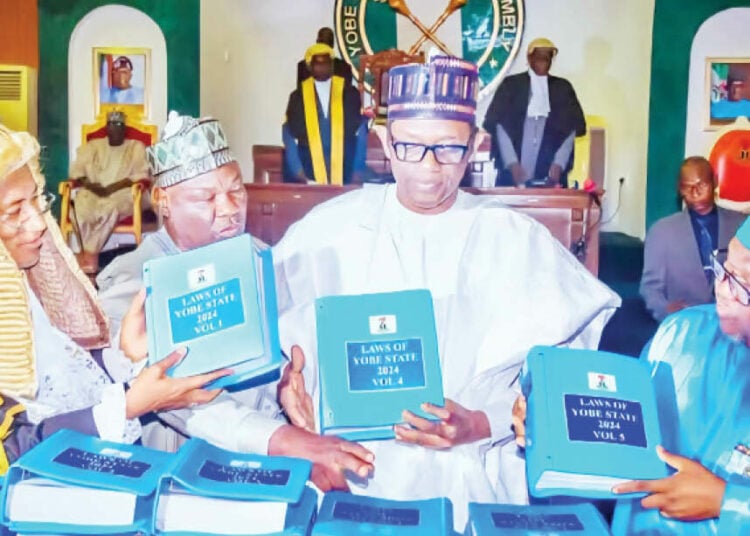 Yobe Governor, Buni (In white) while unveiling the 500 copies of the Compiled and Revised Laws of Yobe State recently adopted by the State House of Assembly