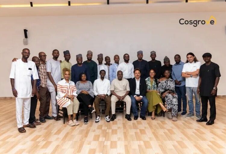 Cosgrove Chairman Rewards Employee 1 ChairmanChief Executive Officer Cosgrove Investment Limited Mr. Umar Abdullahi OFR seated in the middle flanked on both sides and around by management staff of the organisation