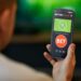 Person holding phone with soccer betting app open.