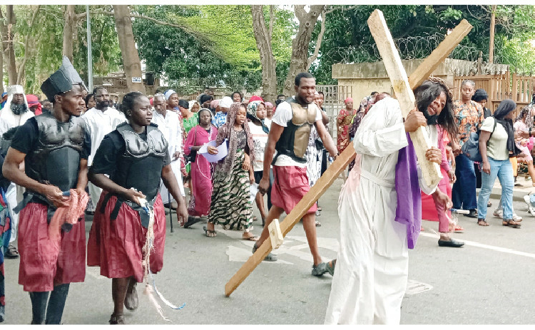Easter Holiday: Federal Govt Places Security Men On Red Alert 1 Catholic faithful dramatising the suffering, crucifixion and death of Jesus Christ at Our Lady Queen of Peace Catholic Church, Utako, Abuja, yesterday. PHOTO: IBRAHIM MOHAMMED