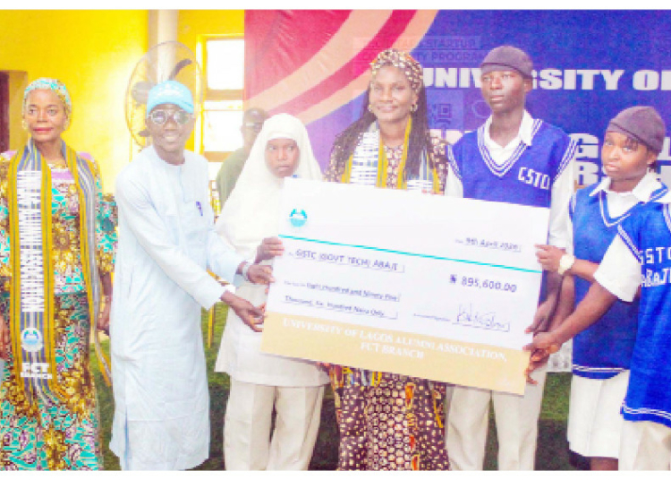UNILAG Alumni Award Scholarships To 28 Indigent Abuja Students 1 L–R: Member, University of Lagos Alumni Association, Kelechi Franklin; Princess Felicia Tor-Anandeh; Teacher, GSTC Abaji, Jerry S.; and students of GSTC Abaji, as Vice-Chairman, UNILAG Alumni Association, FCT Branch, Mrs Julia Davids, presents a scholarship award of N895,600 to the school during the UNILAG Alumni Association scholarship award ceremony in Abuja, yesterday. PHOTO: REUBEN OJOAJOGWU GAD