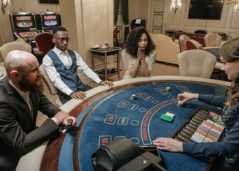 Players watching dealer at blackjack table