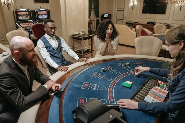 Players watching dealer at blackjack table