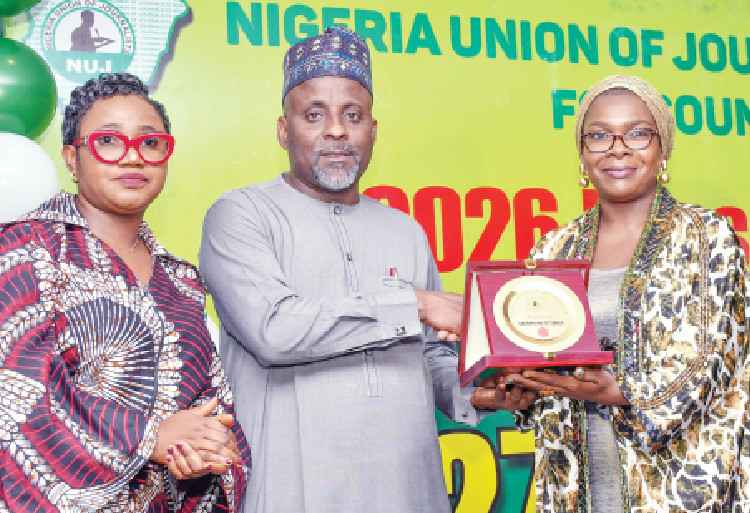 2026 Press Week: NUJ President Urges Urgent Action On Journalists’ Welfare, Press Freedom 1 Chairman, LEADERSHIP Media Group, Zainab Nda-Isaiah (right), receiving the NUJ FCT Council Appreciation Award from the National President of the Nigeria Union of Journalists (NUJ), Alhassan Yahaya (middle), while the Chairman, NUJ FCT Council, Comrade Grace Ike, looks on, during the 2026 NUJ Press Week in Abuja, on Tuesday. PHOTO: IBRAHIM MOHAMMED