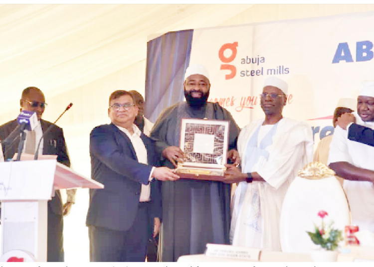 L-R: Chairman, African Industries Group (AIG), Raj Gupta alongside former minister of Finance,  Shamsudeen Usman, presenting a  momento to the Niger State governor, Farmer Dr Umaru Bago at the groundbreaking and handing over of 500 hectares of land to Abuja Steel Mills for Solar farm and AIG Industrial Park in Sabon Wuse, Niger State, on Saturday. PHOTO: AIG