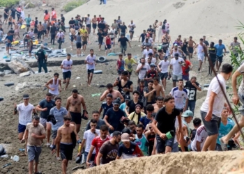 Migrants reach Spanish territory after swimming from Morocco to Ceuta, a Spanish enclave in north Africa, on Thursday. Reduan Dris/EPA/Shutterstock