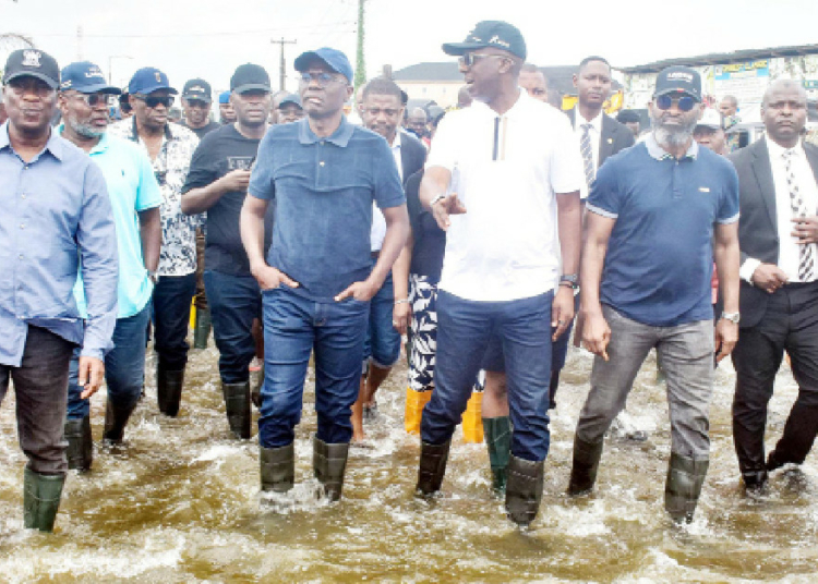 Sanwo-Olu Blames Lagos Flooding On Blocked Waterways, Human Errors 1 L-R: Deputy Governor of Lagos State, Dr Obafemi Hamzat; Lagos State Governor Babajide Sanwo-Olu; Commissioner for Environment and Water Resources, Mr Tokunbo Wahab; Special Adviser to the Governor on Infrastructure, Mr Olufemi Daramola and others, during their visit to a flood affected area in Lagos, yesterday. PHOTO: NAN