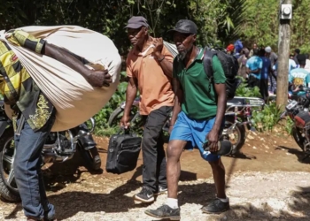 Survivors of the attack fled with whatever belongings they could carryImage: Photo credit: Patrice Noel/REUTERS